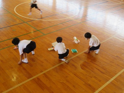 ふわふわゴーの作品を仰いで動かす１年１組の子ども