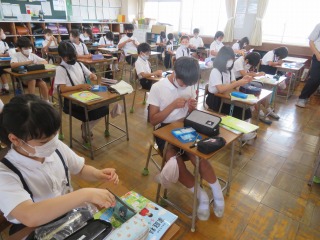 裁縫道具から針と糸を取り出し，針に糸を通す５年１組の子どもたち